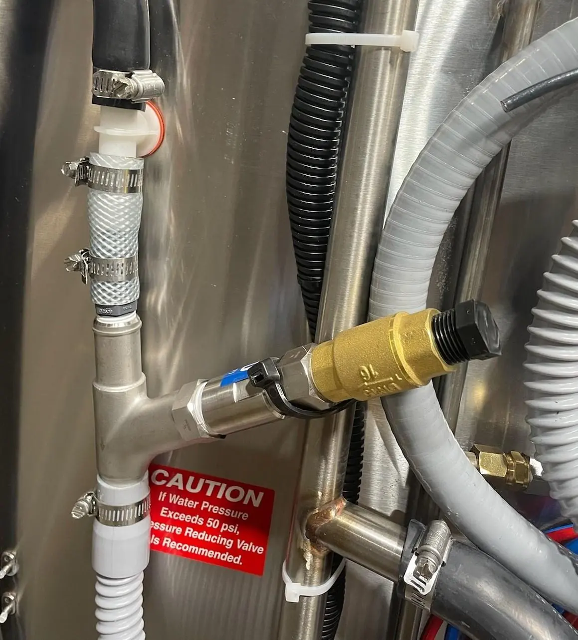 Factory installed Drain Water Tempering kit with black plug.