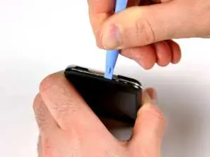 Using a plastic opening tool to separate the case panels.