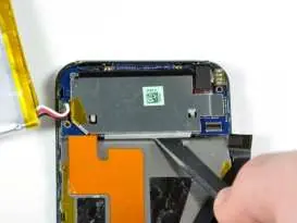 Loosening the logic board with a spudger.