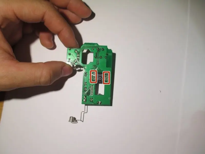 The motherboard with the I.C. chip highlighted for desoldering.
