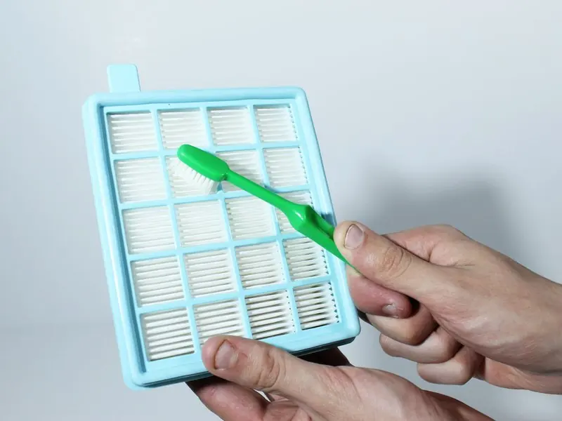 Use a toothbrush to clean the pleated side of the filter.