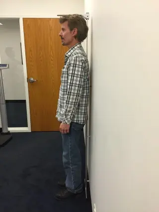 Correct patient positioning for height measurement.