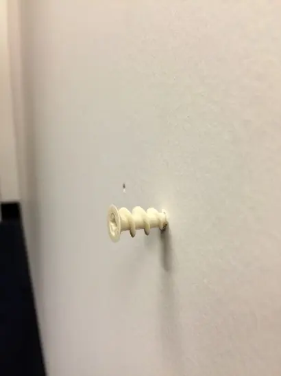Installing a drywall anchor.