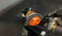 Inserting the LED turn signal lamp into the drilled hole.