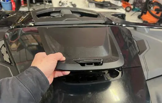 Removing front trims with a pry tool.