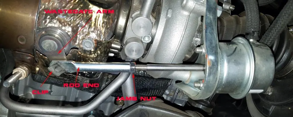 Wastegate adjustment components: rod end, clip, and jamb nut.