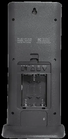 Locate the battery compartment and control buttons on the back of the device.