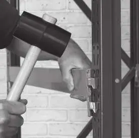 Using a rubber mallet to seat the cross beam