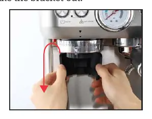 Pressing the red release button to unlock the grinder