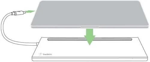Placing the laptop on the dock and connecting the USB-C cable.