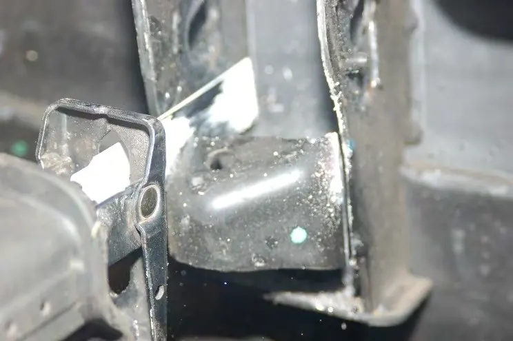 Cutting the bump stop from the upper control arm mount.