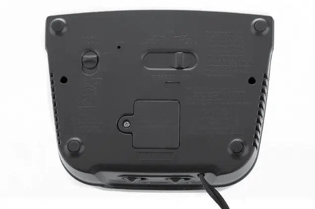 Rear view of the alarm clock showing switches and battery compartment.
