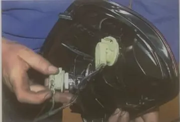 Disconnecting the tail light sockets and bulbs.