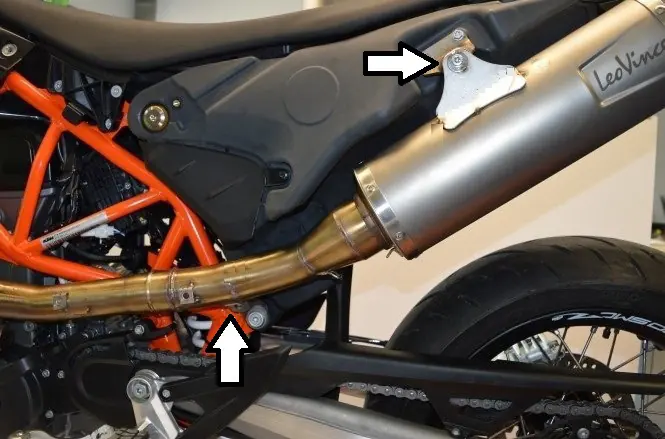 Secure the silencer to the frame mounting points.