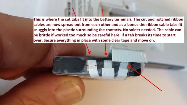 Connecting the ribbon cable to the battery terminals.