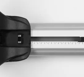 Align the roof rack foot with the measurement scale on the crossbar.