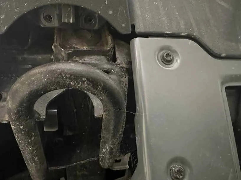 Removing M6 bolts from under the tow hooks.