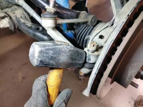 Loosen the tie rod end nut.