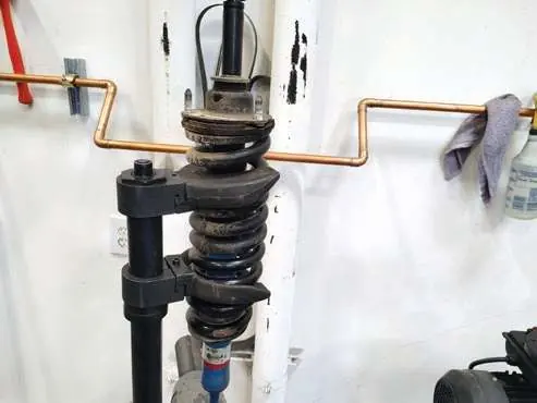 Secure the spring compressor.