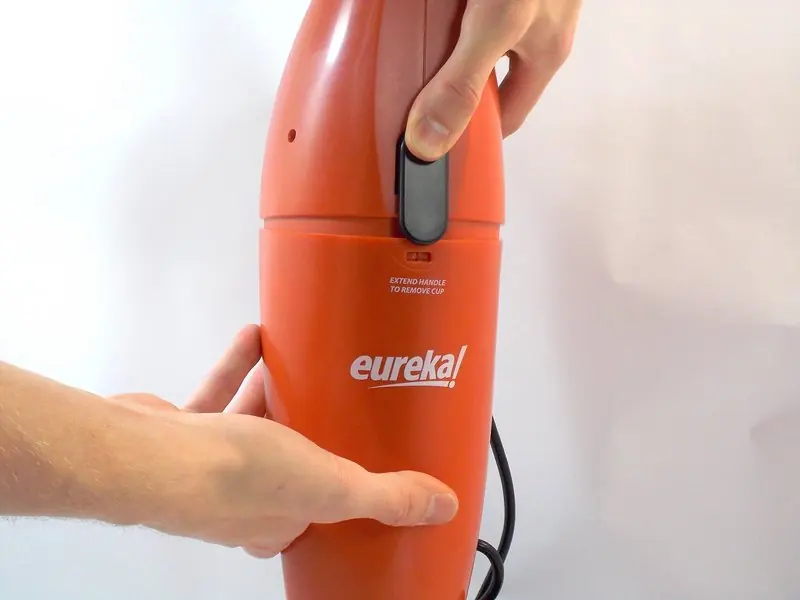 Press the black separator switch to release the bottom half.