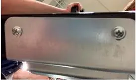 Removing the bracket from the bottom of the door.